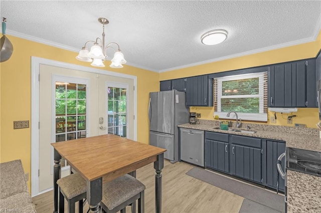 5001 Robert Andrew Rd, Greensboro, NC 27406 - kitchen with appliances with stainless steel finishes, a chandelier, light wood-style floors, a textured ceiling, and french doors