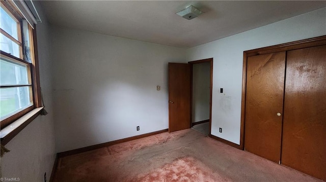 2308 Sprague St, Winston-Salem, NC 27107 - unfurnished bedroom with light carpet, multiple windows, baseboards, and a closet