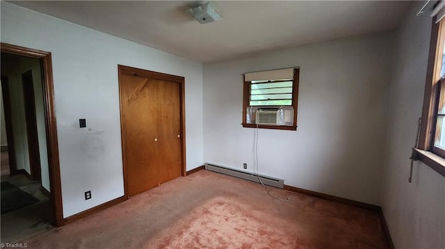 2308 Sprague St, Winston-Salem, NC 27107 - unfurnished bedroom featuring baseboard heating, cooling unit, carpet flooring, a closet, and baseboards