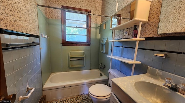 2308 Sprague St, Winston-Salem, NC 27107 - full bath with wallpapered walls, tile walls, washtub / shower combination, toilet, and a wainscoted wall