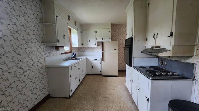 2308 Sprague St, Winston-Salem, NC 27107 - kitchen featuring black appliances, wallpapered walls, light flooring, a sink, and white cabinets