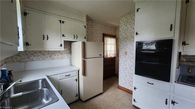 2308 Sprague St, Winston-Salem, NC 27107 - kitchen with freestanding refrigerator, oven, wallpapered walls, a sink, and light floors