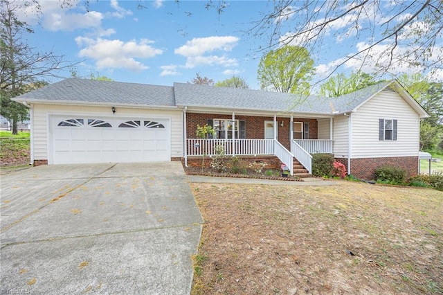 1300 W Vandalia Rd, Greensboro, NC 27406 - single story home with brick siding, covered porch, concrete driveway, and an attached garage