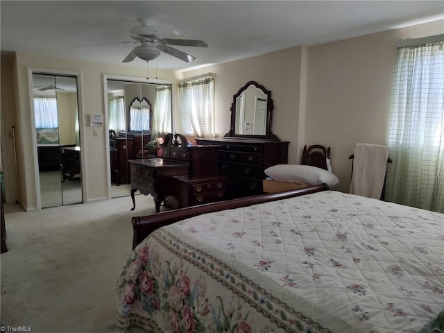 210 Grinton Ave, Wilkesboro, NC 28697 - carpeted bedroom featuring multiple closets, multiple windows, and a ceiling fan