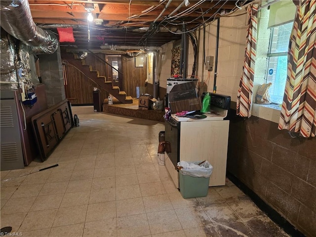 210 Grinton Ave, Wilkesboro, NC 28697 - basement featuring washer / dryer, concrete block wall, and stairs