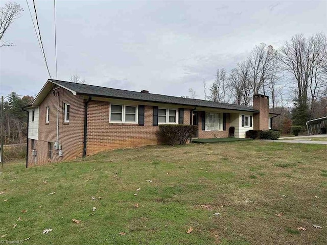 210 Grinton Ave, Wilkesboro, NC 28697 - ranch-style home featuring brick siding, a front lawn, and a chimney