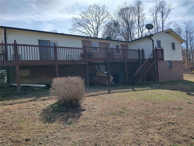210 Grinton Ave, Wilkesboro, NC 28697 - rear view of property featuring a deck, stairway, a lawn, and brick siding