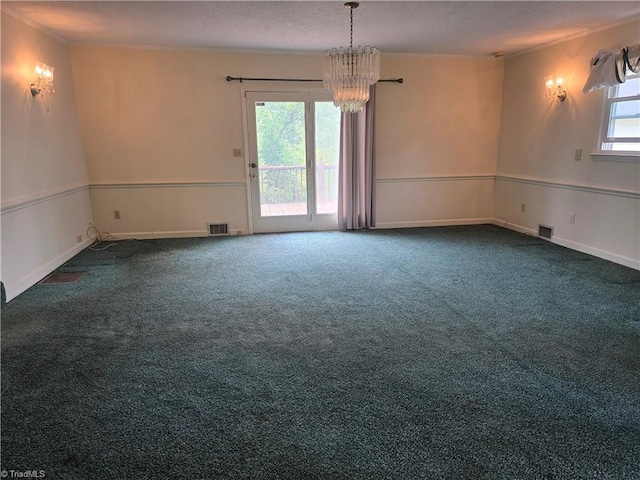 210 Grinton Ave, Wilkesboro, NC 28697 - empty room with a chandelier, dark colored carpet, and crown molding