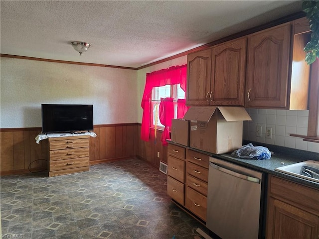 210 Grinton Ave, Wilkesboro, NC 28697 - kitchen with dishwasher, a wainscoted wall, dark stone finish floors, a textured ceiling, and dark countertops