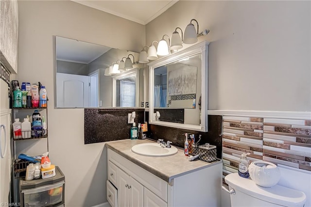 bathroom featuring crown molding, tasteful backsplash, toilet, and vanity