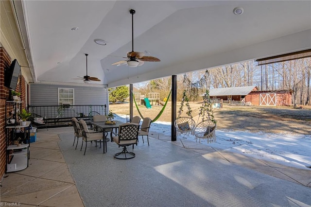 view of patio / terrace with a playground, outdoor dining area, and ceiling fan