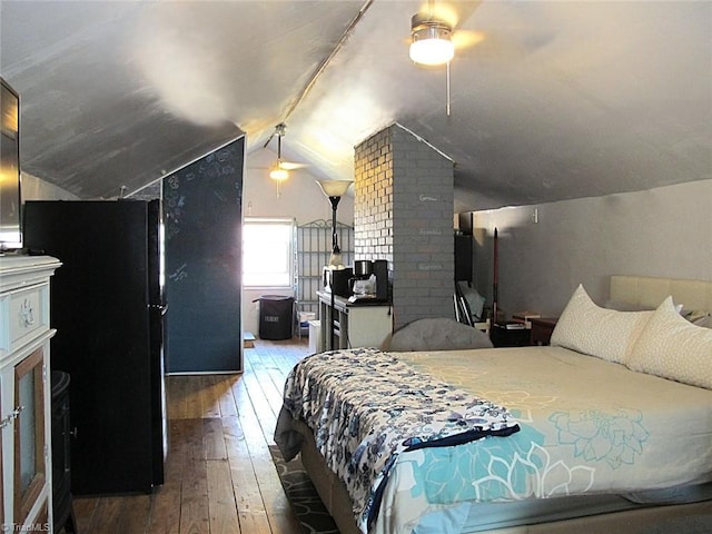 bedroom featuring a ceiling fan, lofted ceiling, and wood-type flooring