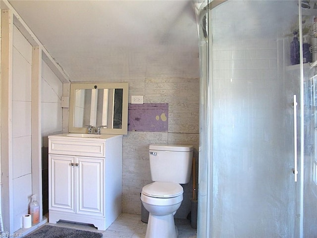 full bath featuring vanity, tile walls, toilet, and walk in shower