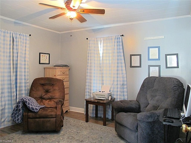 sitting room featuring ceiling fan, wood finished floors, and ornamental molding