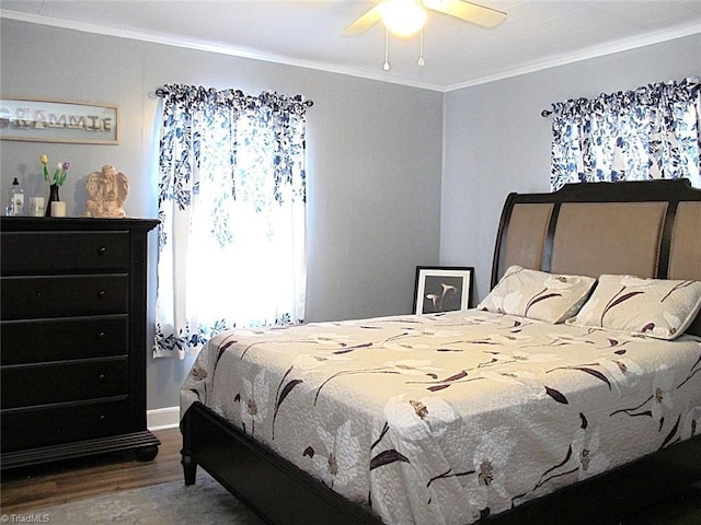 bedroom with ceiling fan, wood finished floors, and ornamental molding