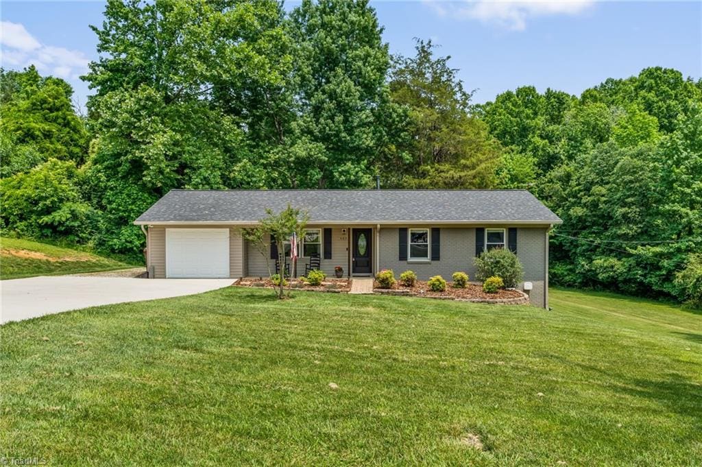 4879 Colonial Cir, Trinity, NC 27370 - view of front of property with driveway, an attached garage, and a front yard