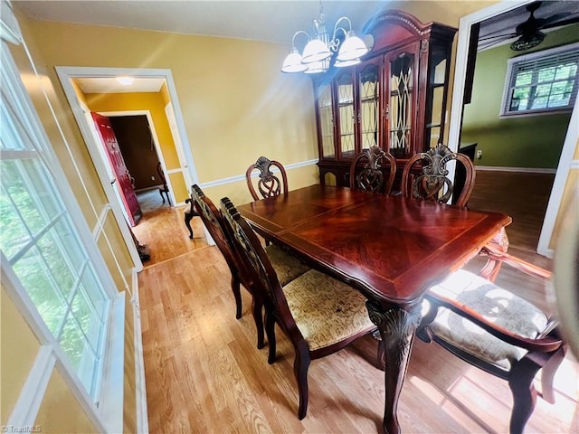 dining area featuring light hardwood / wood-style flooring and a chandelier