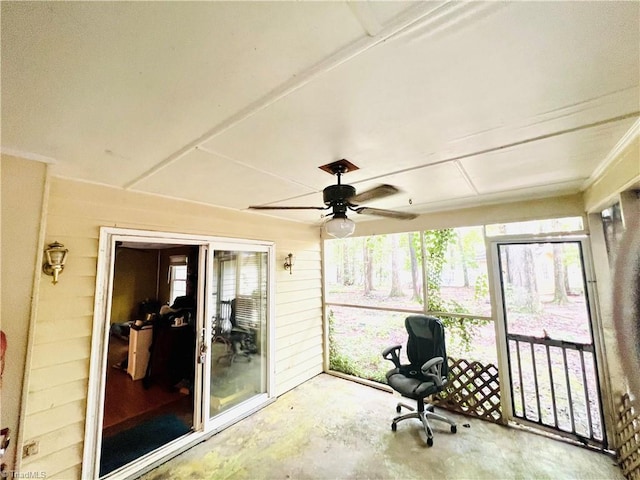 unfurnished sunroom with ceiling fan