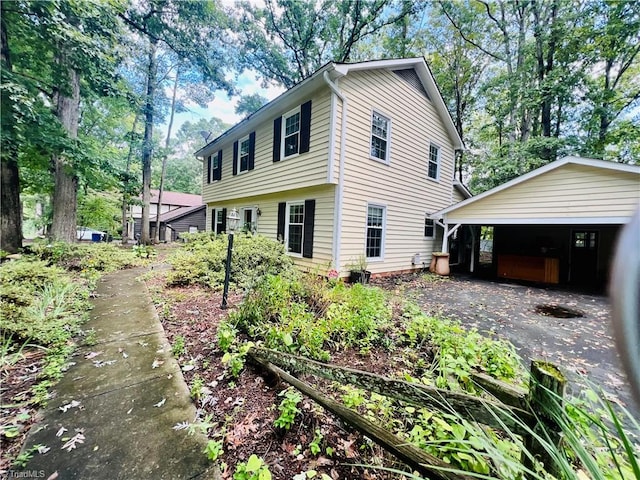 view of side of home with a carport