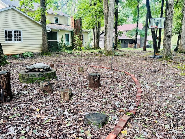 view of yard featuring an outdoor fire pit