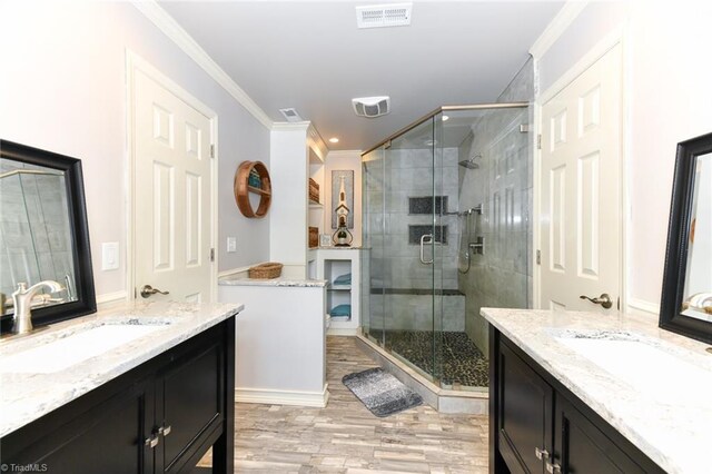 bathroom featuring walk in shower, ornamental molding, and vanity