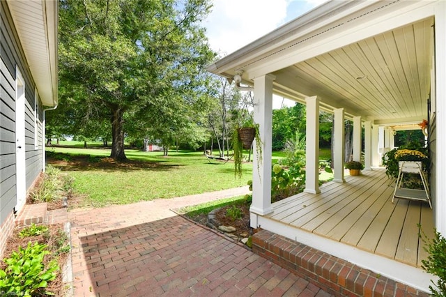 wooden deck with a yard and covered porch