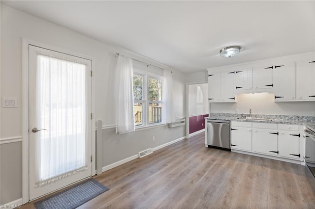 kitchen featuring white cabinets, light hardwood / wood-style flooring, sink, and dishwasher