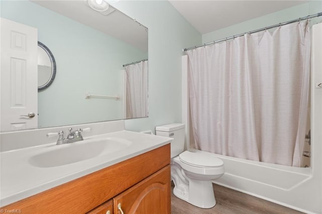 full bathroom featuring vanity, toilet, hardwood / wood-style floors, and shower / bath combo