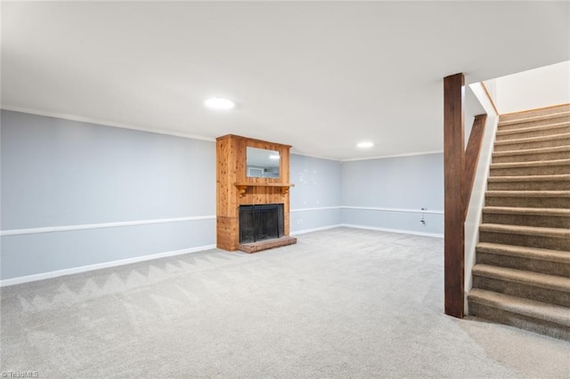 unfurnished living room with crown molding and carpet flooring