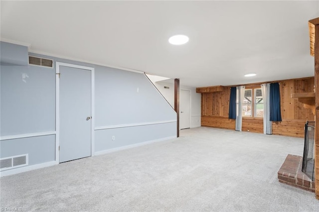 basement with light colored carpet and wooden walls