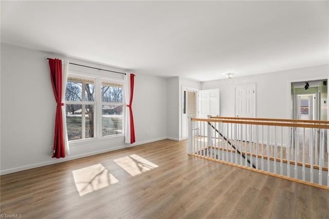 empty room with hardwood / wood-style flooring