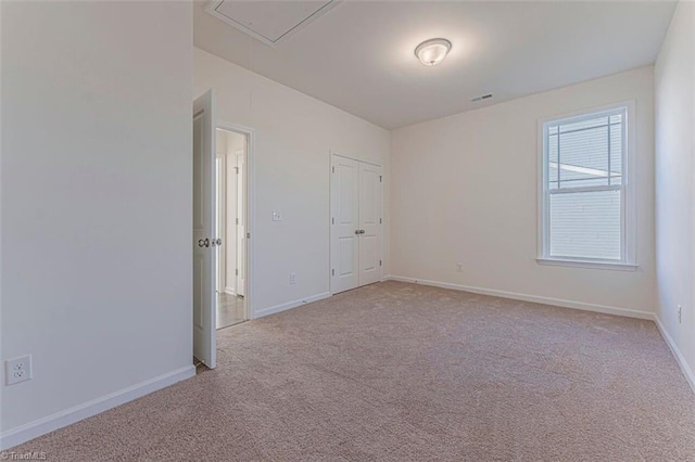 unfurnished room featuring light carpet