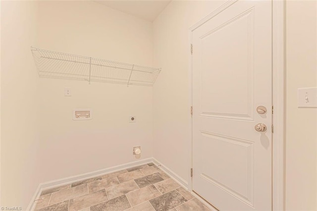 clothes washing area with light tile flooring and hookup for an electric dryer