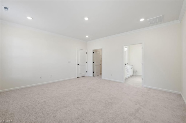 empty room with light colored carpet and crown molding