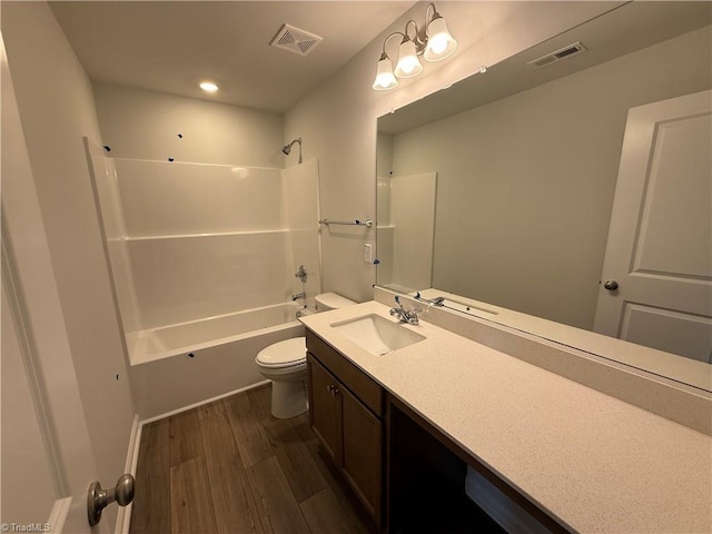 2557 Raspberry Hill Dr, Winston-Salem, NC 27106 - full bathroom featuring vanity, toilet, wood finished floors, and visible vents