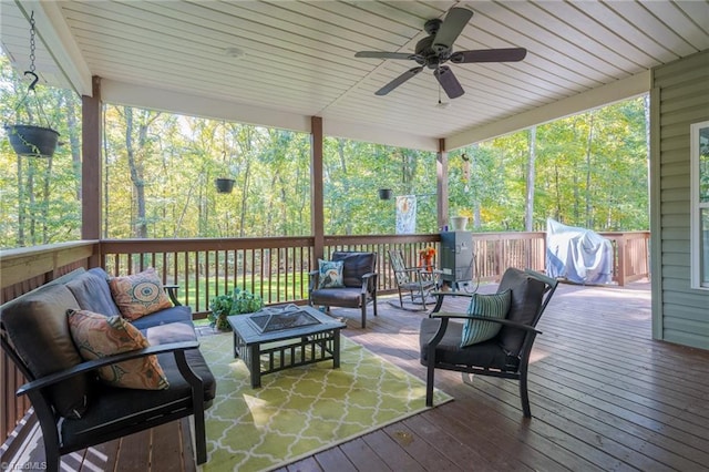 deck with a grill, an outdoor living space with a fire pit, and ceiling fan