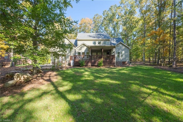 rear view of property featuring a yard