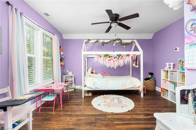 bedroom with dark hardwood / wood-style flooring and ceiling fan