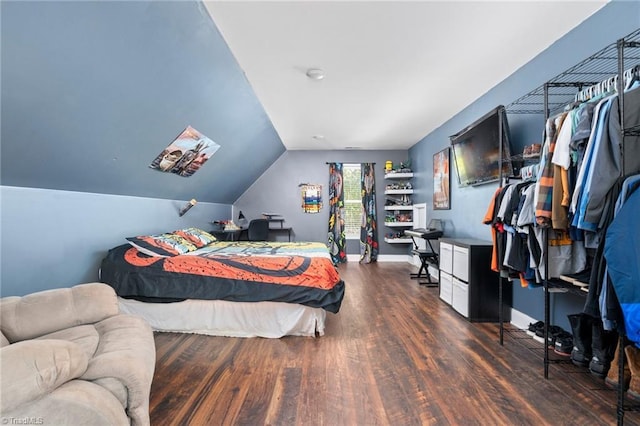 bedroom featuring dark hardwood / wood-style flooring and vaulted ceiling