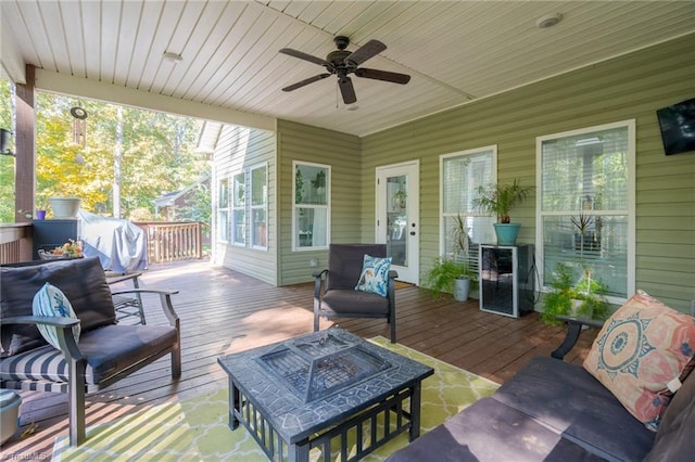 sunroom featuring wood ceiling and ceiling fan