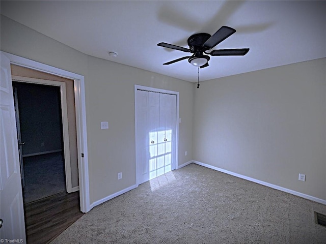 unfurnished bedroom featuring a closet, ceiling fan, and carpet floors