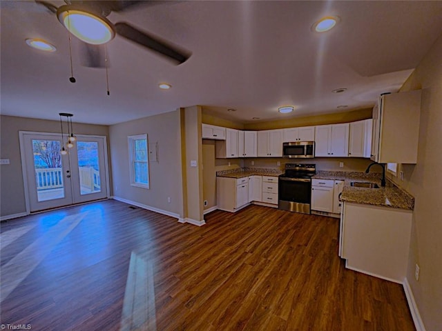 kitchen featuring white cabinetry, sink, hanging light fixtures, dark hardwood / wood-style flooring, and appliances with stainless steel finishes