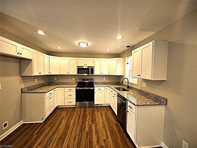 kitchen with sink, hanging light fixtures, stainless steel appliances, dark hardwood / wood-style flooring, and white cabinets