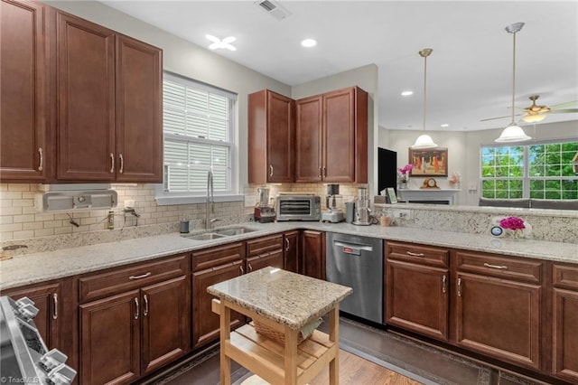 1934 Rubywood St, Greensboro, NC 27405 - kitchen featuring light stone counters, a sink, backsplash, a toaster, and stainless steel dishwasher