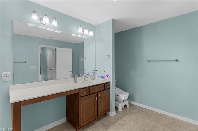 1934 Rubywood St, Greensboro, NC 27405 - bathroom featuring vanity, baseboards, and toilet