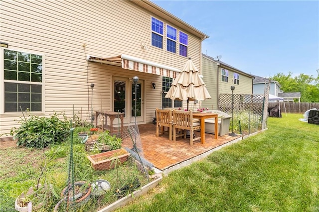 1934 Rubywood St, Greensboro, NC 27405 - rear view of property with a yard, fence, a patio area, and a vegetable garden