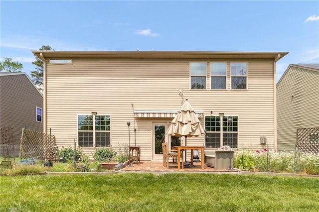 1934 Rubywood St, Greensboro, NC 27405 - back of property featuring a yard, fence, and a patio area