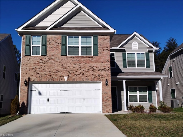 view of front of property featuring cooling unit, a garage, and a front lawn