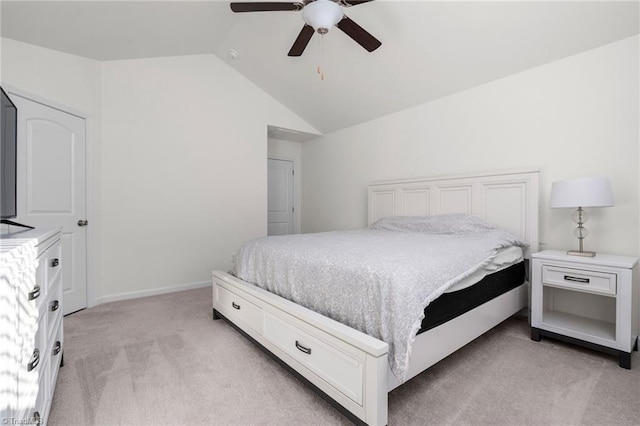 carpeted bedroom with vaulted ceiling and ceiling fan