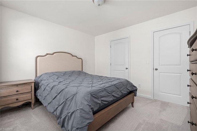 bedroom featuring light carpet